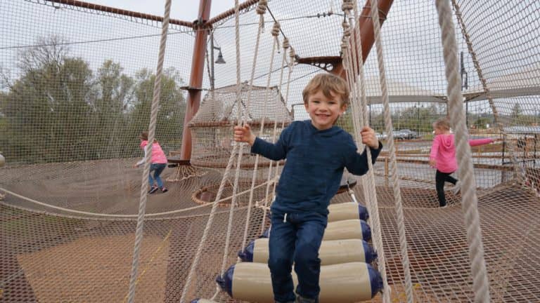 Kids climbing in the netted Kidz Kove play area
