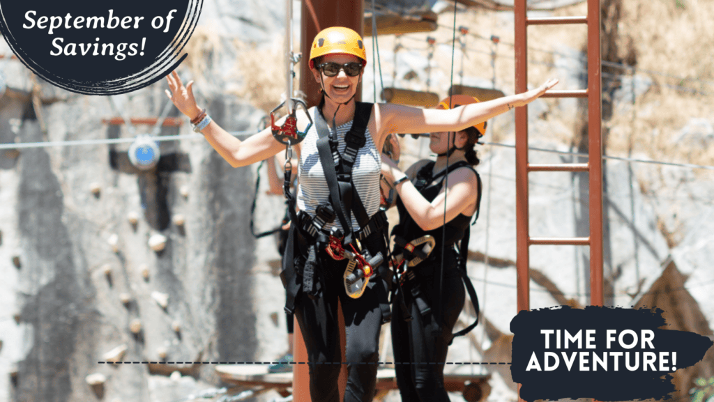 Two people wearing harnesses and helmets cheerfully pose on a zip line with text overlays reading "September savings" and "time for adventure!