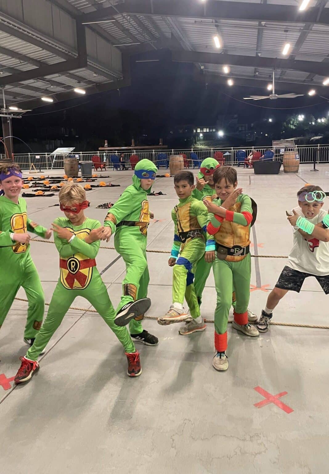 Kids in Halloween costumes posing together at a Fright Climb night at Quarry Park Adventures in Rocklin